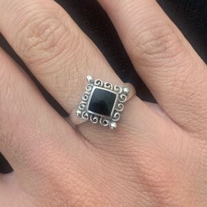 Silver ring with swirls and black rhinestone diamond shape